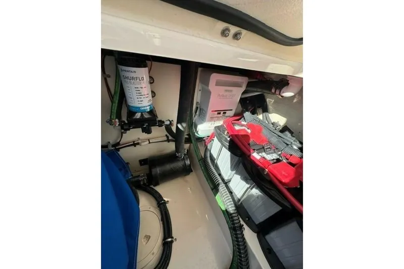 Slide: The Image of 2025 Grady-White Freedom 375 boat interior showing battery and pump system components. - 12
