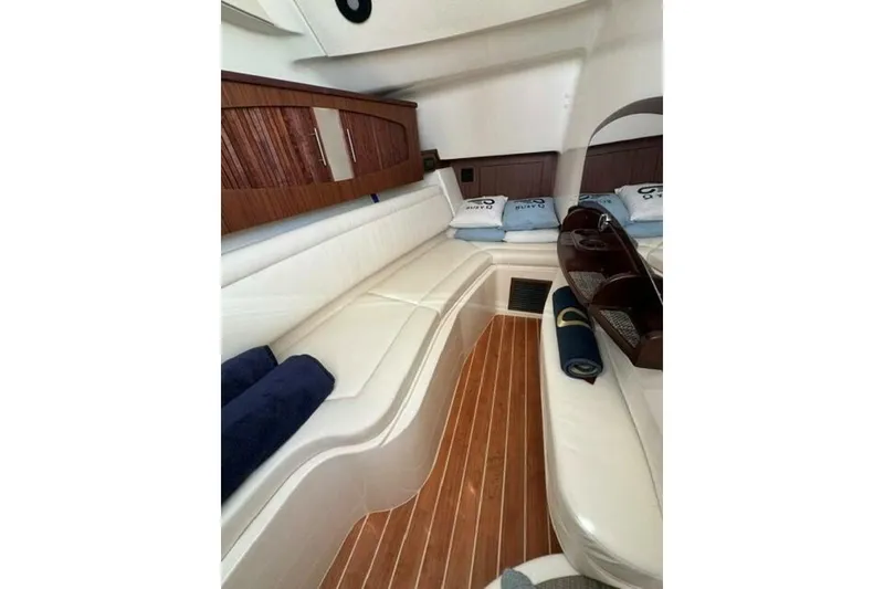 Slide: The Image of Luxurious interior of 2025 Grady-White Freedom 375 boat with white seating and wooden accents. - 4