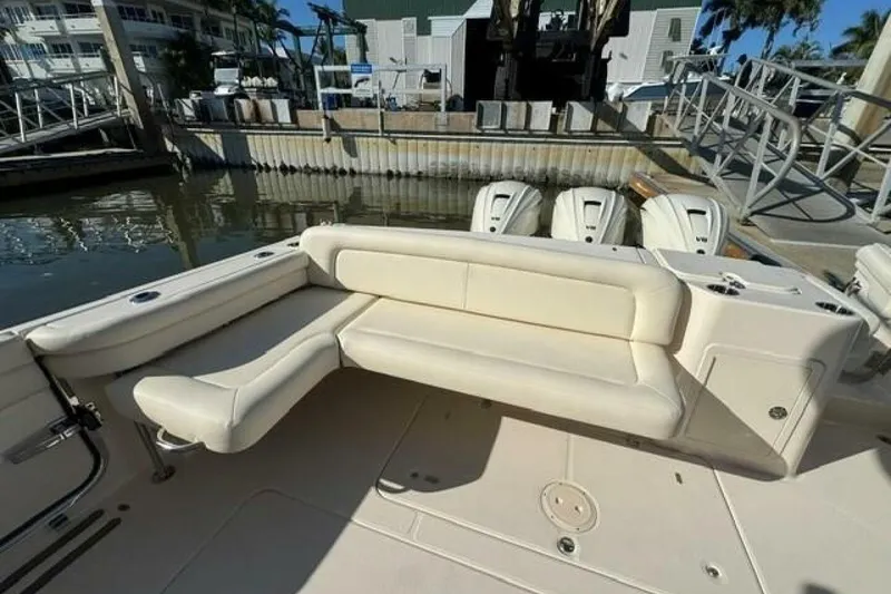 Slide: The Image of 2025 Grady-White Freedom 375 boat with beige seating and triple outboard engines. - 6