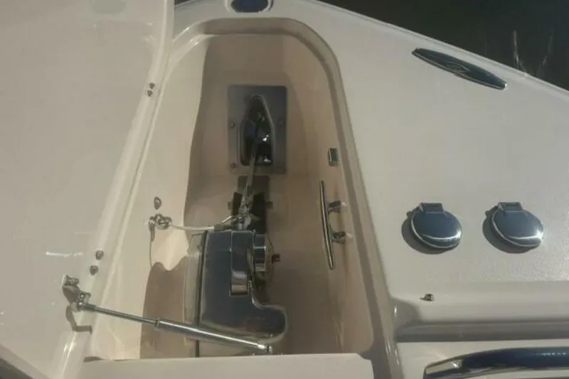Slide: The Image of 2025 Grady-White Freedom 375 boat anchor compartment with polished metal fittings. - 8