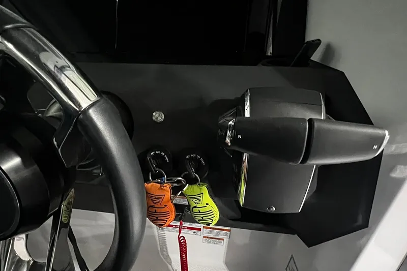 Slide: The Image of Steering wheel and controls of 2025 Axopar 29 XC Cross Cabin boat. - 13