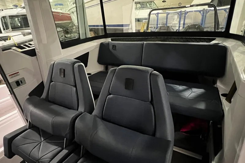 Slide: The Image of Interior of 2025 Axopar 29 XC Cross Cabin with modern seating and sleek design. - 15