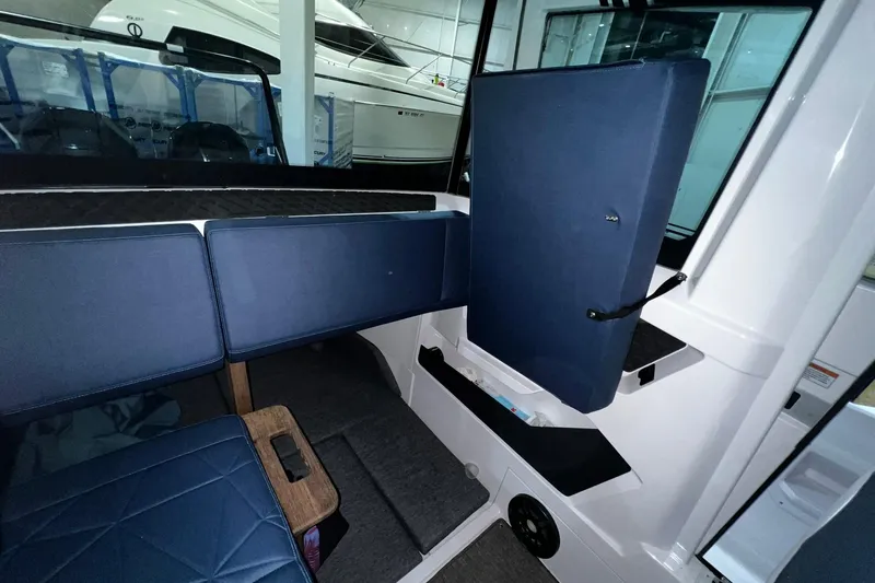 Slide: The Image of 2025 Axopar 29 XC Cross Cabin interior with blue seating and modern design. - 17