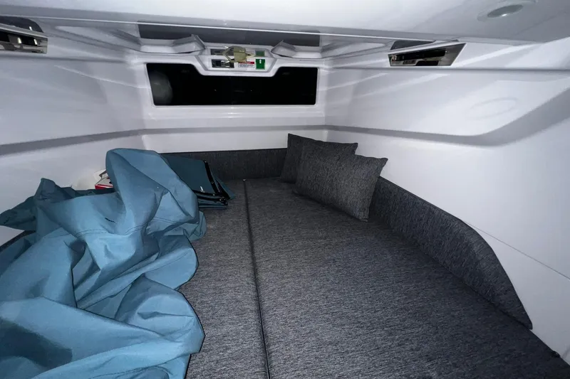 Slide: The Image of 2025 Axopar 29 XC Cross Cabin interior with cozy bedding and modern design. - 19