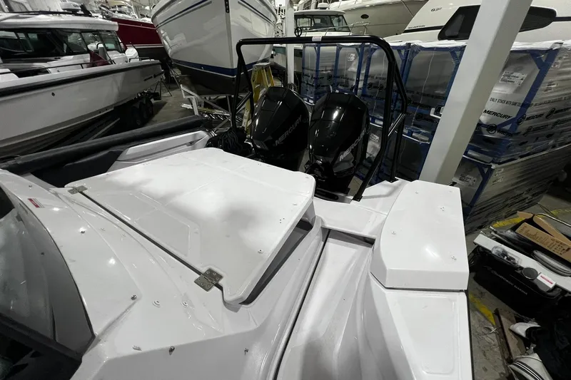 Slide: The Image of 2025 Axopar 29 XC Cross Cabin with dual Mercury outboard engines in a showroom. - 20