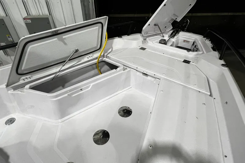 Slide: The Image of 2025 Axopar 29 XC Cross Cabin boat interior with open storage compartments. - 3