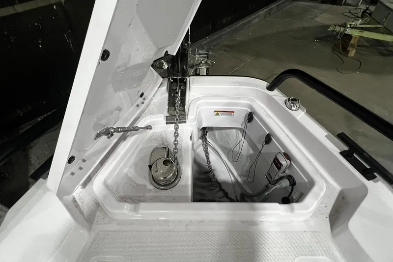 Slide: The Image of 2025 Axopar 29 XC Cross Cabin anchor compartment with chain and winch. - 5