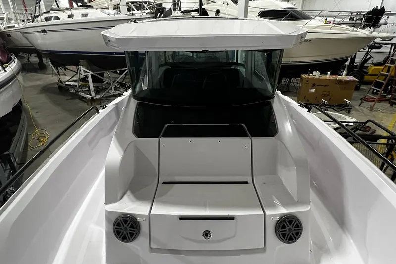 Slide: The Image of 2025 Axopar 29 XC Cross Cabin boat in a showroom, showcasing sleek design and modern features. - 7