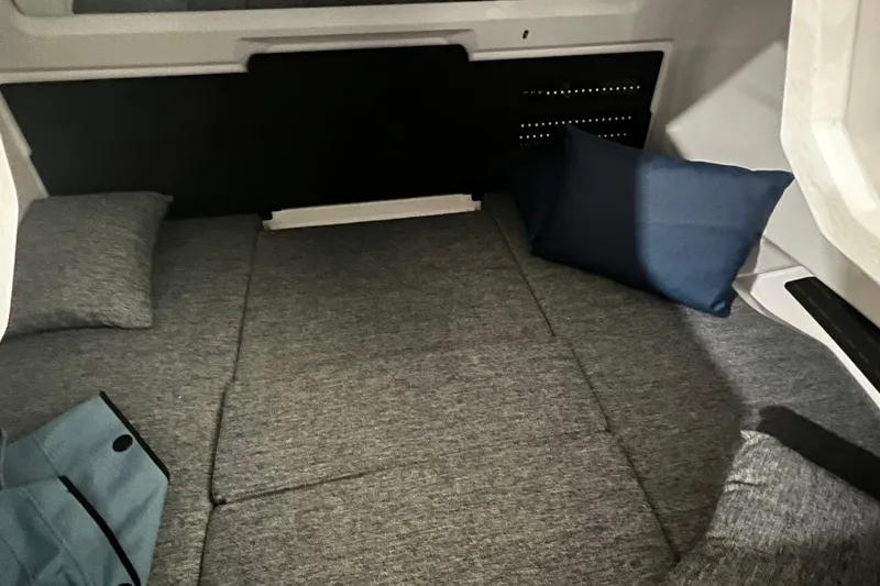 Slide: The Image of 2025 Axopar 29 XC Cross Cabin interior with gray cushions and pillows. - 8