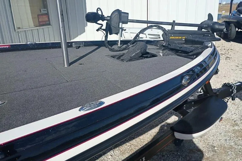 Slide: The Image of 2018 Ranger Z521L boat deck with trolling motor, parked outside a building. - 4