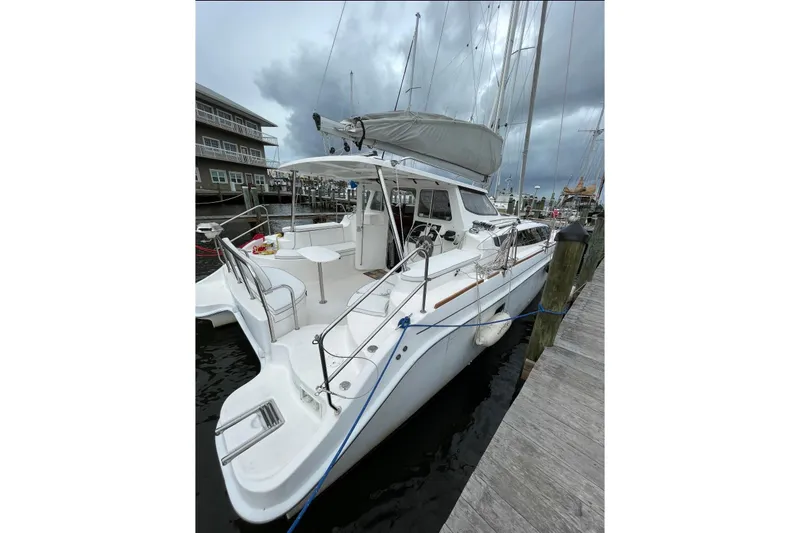 Slide: The Image of 2013 Gemini Legacy 35 catamaran docked at marina under cloudy skies. - 1