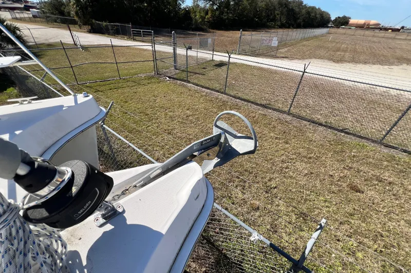 Slide: The Image of 2013 Gemini Legacy 35 boat anchor and winch near fenced yard. - 101
