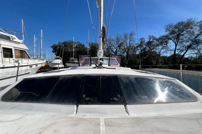 Slide: The Image of 2013 Gemini Legacy 35 sailboat docked, surrounded by other boats, under clear blue sky. - 111