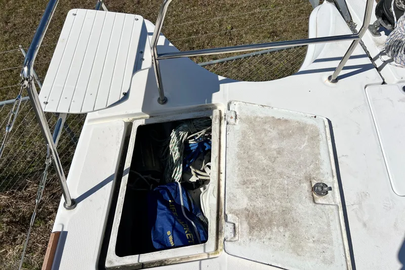Slide: The Image of Open storage compartment on 2013 Gemini Legacy 35 boat deck, containing ropes and gear. - 120