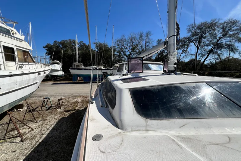 Slide: The Image of 2013 Gemini Legacy 35 sailboat in a boatyard under clear blue sky. - 126