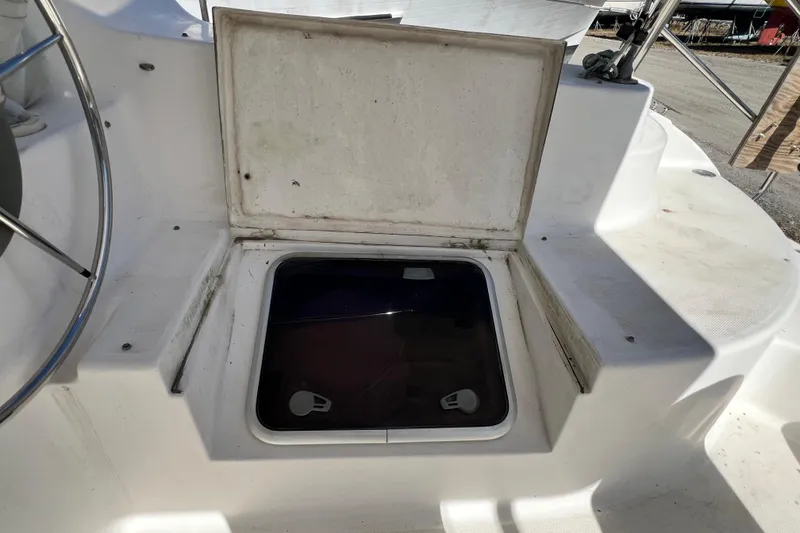 Slide: The Image of Open hatch on 2013 Gemini Legacy 35 boat deck, showing storage compartment. - 129