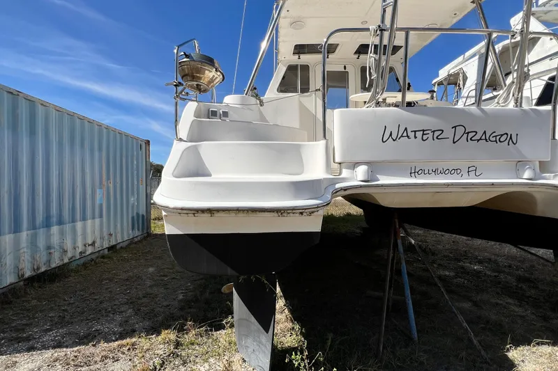 Slide: The Image of Catamaran "Water Dragon" Gemini Legacy 35, 2013, docked in Hollywood, FL, beside a shipping container. - 137