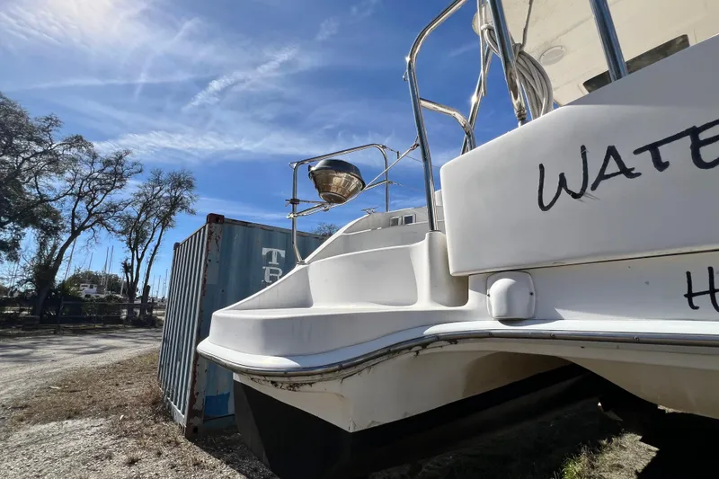 Slide: The Image of 2013 Gemini Legacy 35 catamaran docked near shipping container under clear blue sky. - 138