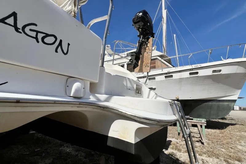 Slide: The Image of 2013 Gemini Legacy 35 catamaran on dry dock with visible outboard motor. - 140
