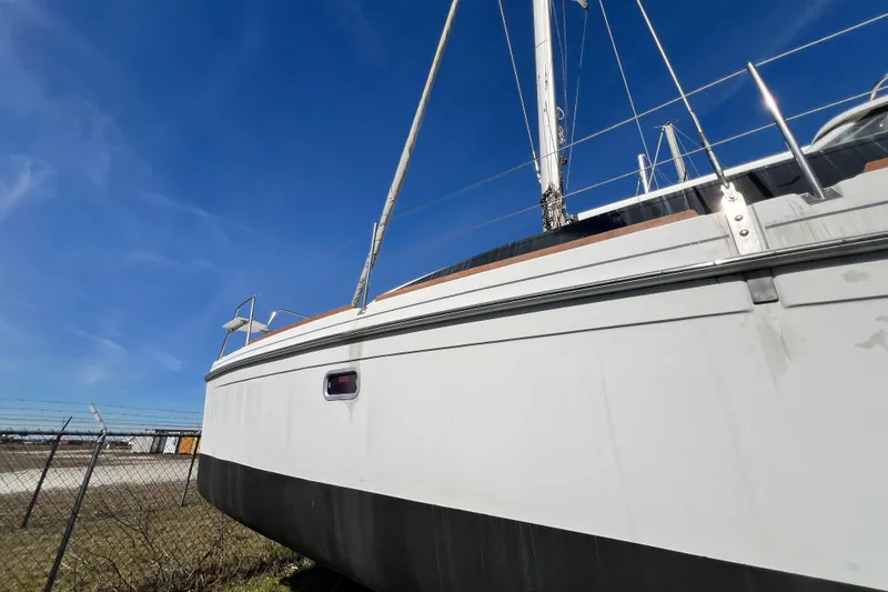 Slide: The Image of 2013 Gemini Legacy 35 sailboat on land under clear blue sky. - 145