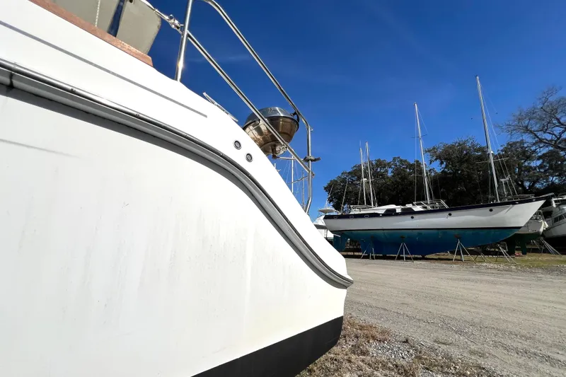 Slide: The Image of Sailboats in a boatyard, featuring a 2013 Gemini Legacy 35 under a clear blue sky. - 146