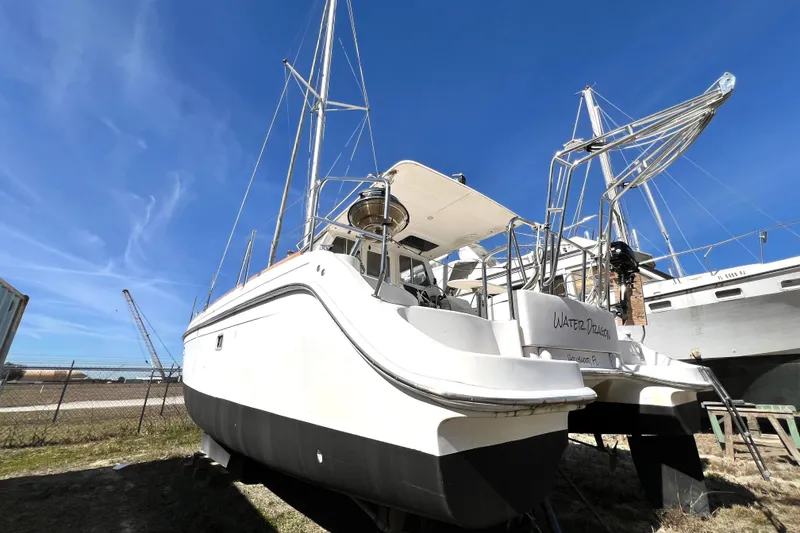 Slide: The Image of 2013 Gemini Legacy 35 catamaran on land, clear blue sky background. - 149
