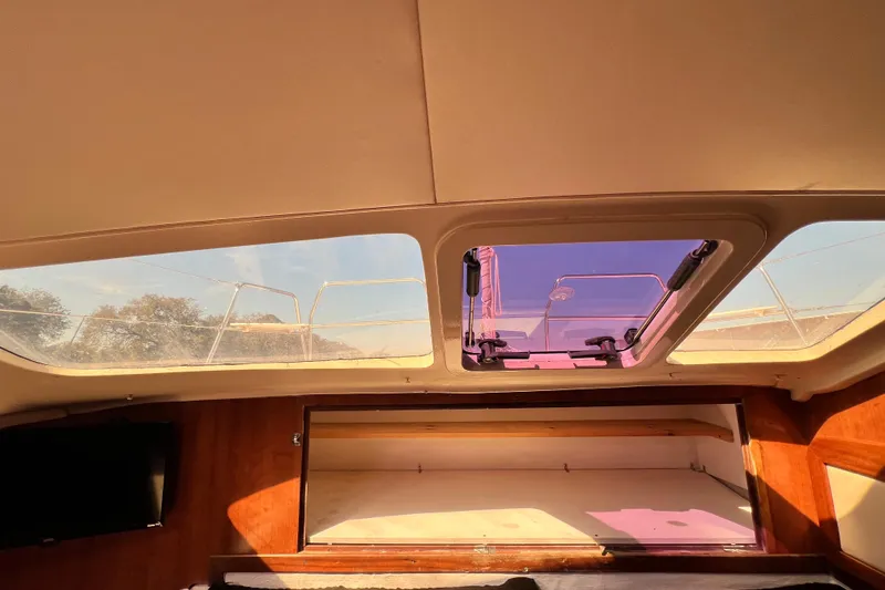 Slide: The Image of Interior view of 2013 Gemini Legacy 35 sailboat with open skylight and wooden accents. - 15