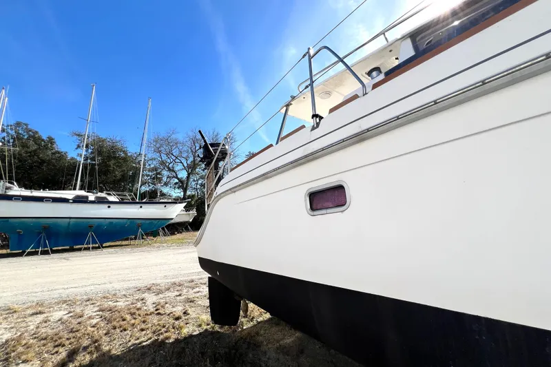 Slide: The Image of 2013 Gemini Legacy 35 sailboat on land, clear sky, other boats in background. - 154