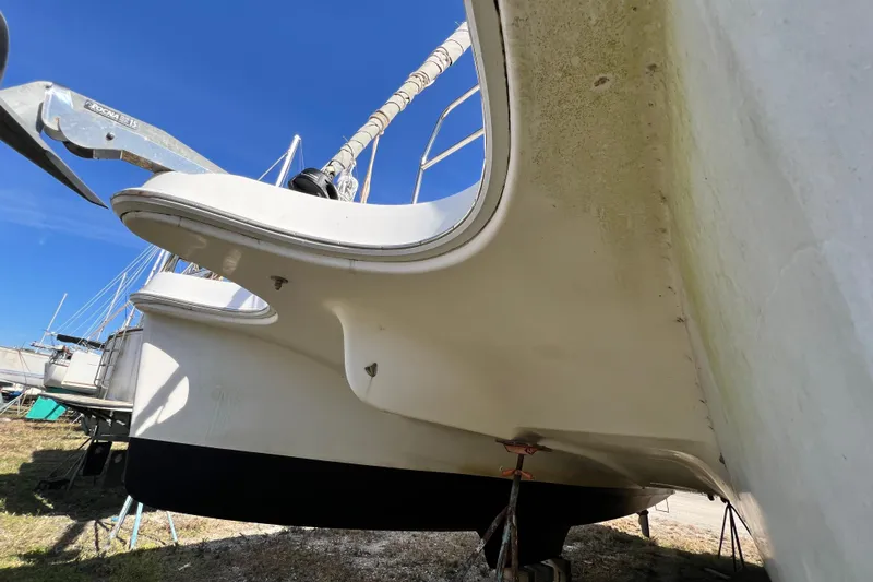 Slide: The Image of 2013 Gemini Legacy 35 catamaran on land, showing hull and rudder details. - 158