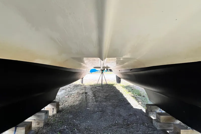 Slide: The Image of Underneath view of 2013 Gemini Legacy 35 catamaran hull on wooden blocks. - 162
