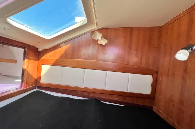 Slide: The Image of Interior cabin of 2013 Gemini Legacy 35 sailboat with wood paneling and skylight. - 17