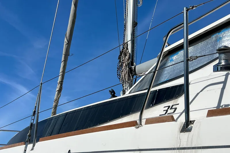 Slide: The Image of Sailboat Gemini Legacy 35, 2013 model, against a clear blue sky. - 170