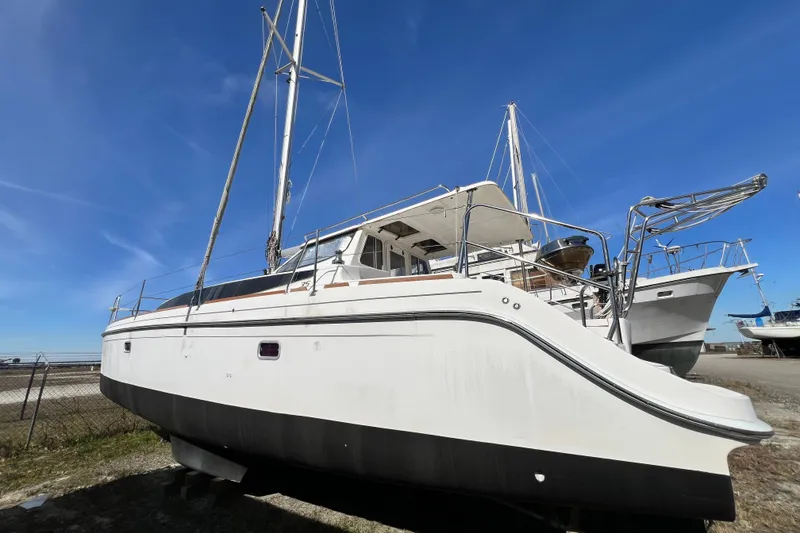 Slide: The Image of 2013 Gemini Legacy 35 catamaran on land under clear blue sky. - 174