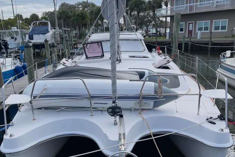 Slide: The Image of 2013 Gemini Legacy 35 catamaran docked at marina with inflatable boat on deck. - 2