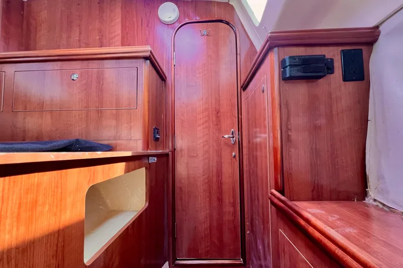 Slide: The Image of Interior of 2013 Gemini Legacy 35 sailboat with wooden cabinetry and door. - 23