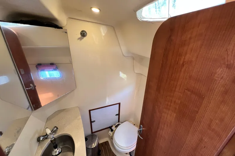 Slide: The Image of Compact bathroom in 2013 Gemini Legacy 35 boat with sink, mirror, and toilet. - 29