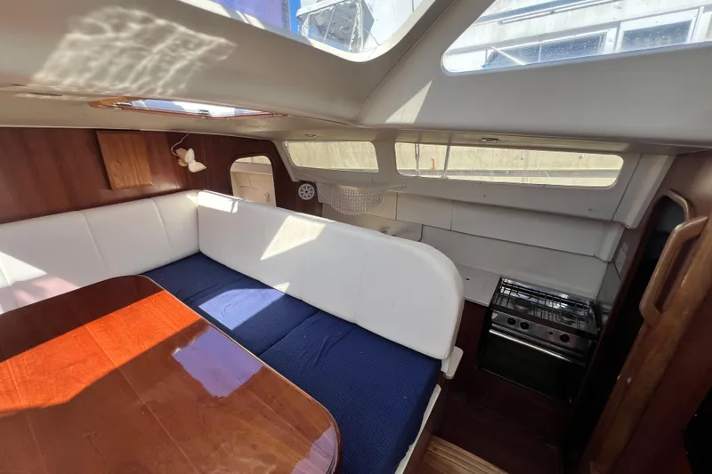 Slide: The Image of Interior of 2013 Gemini Legacy 35 sailboat with dining area and kitchenette. - 38
