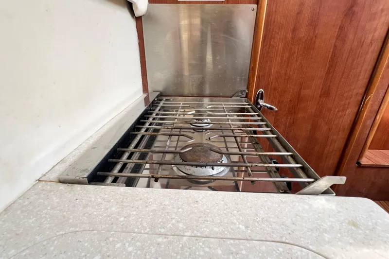 Slide: The Image of Stove in 2013 Gemini Legacy 35 yacht kitchen, featuring stainless steel burners and wooden cabinetry. - 48