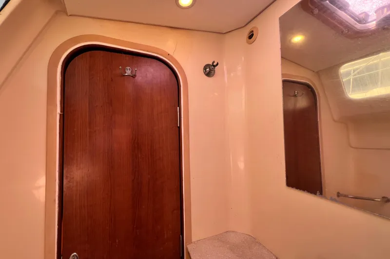 Slide: The Image of Interior of 2013 Gemini Legacy 35 boat with wooden door and mirror. - 59