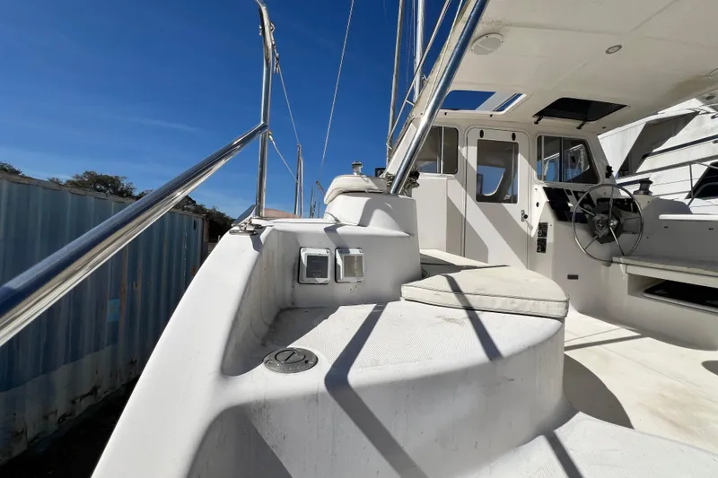 Slide: The Image of 2013 Gemini Legacy 35 sailboat cockpit with steering wheel and seating under clear blue sky. - 70