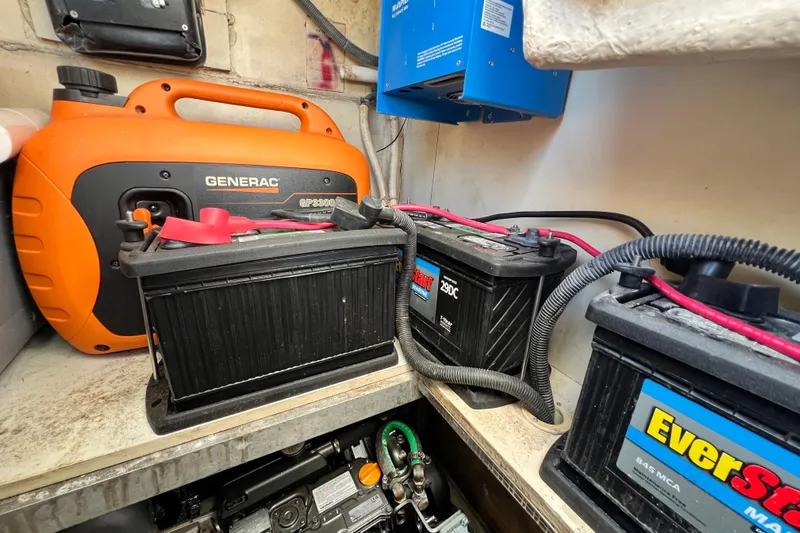 Slide: The Image of Battery compartment of a 2013 Gemini Legacy 35 with generator and wiring. - 86