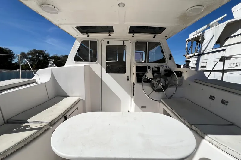 Slide: The Image of Interior view of 2013 Gemini Legacy 35 boat cockpit with steering wheel and seating. - 93