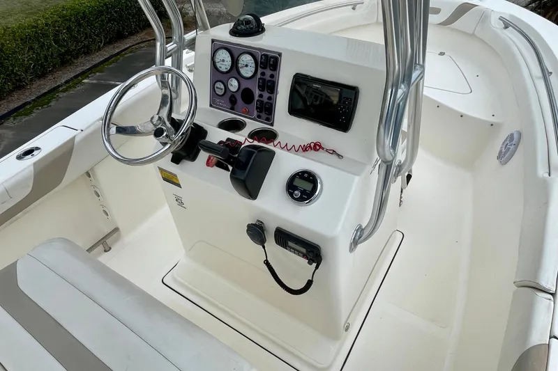 Slide: The Image of 2013 Pioneer 197 Sportfish boat console with steering wheel and navigation controls. - 12
