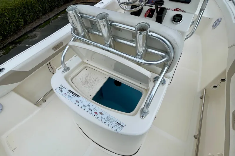Slide: The Image of 2013 Pioneer 197 Sportfish boat interior with rod holders and storage compartment. - 15