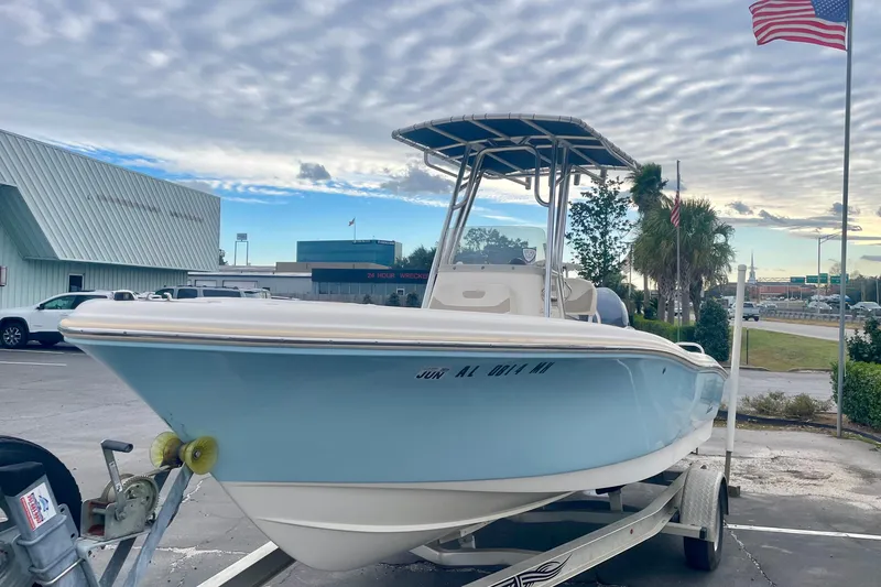 Slide: The Image of 2013 Pioneer 197 Sportfish boat on trailer, parked outdoors under cloudy sky. - 3