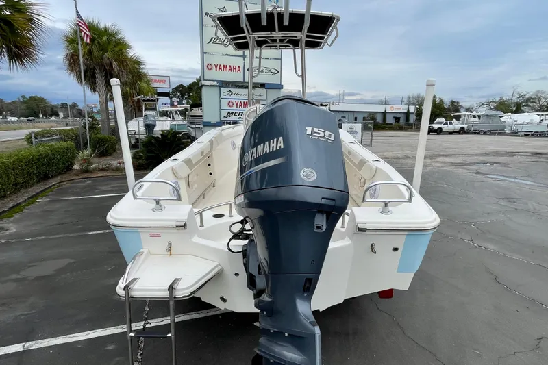 Slide: The Image of 2013 Pioneer 197 Sportfish boat with Yamaha 150 engine, parked outdoors. - 7