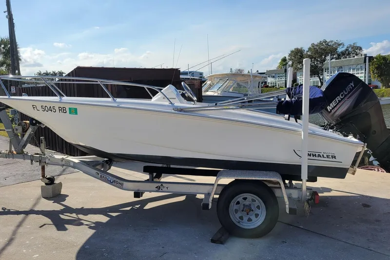 The Image of 2015 Boston Whaler 150 Super Sport boat on trailer with Mercury engine. - 0