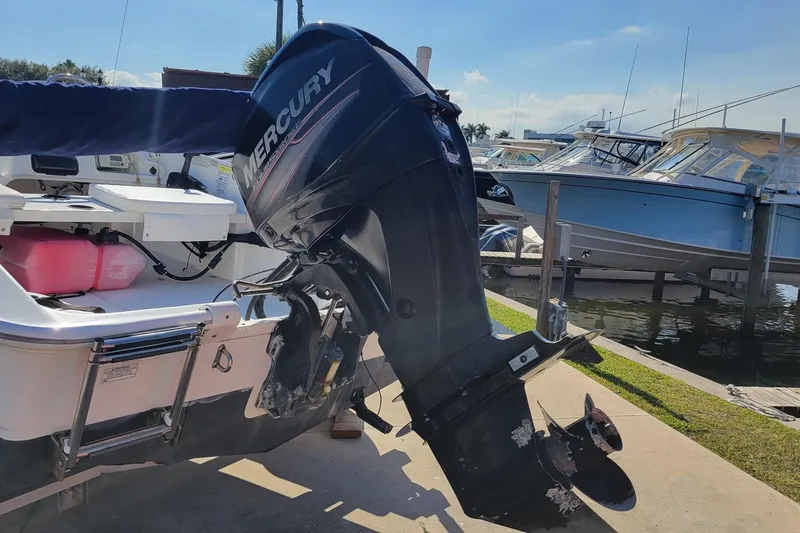Slide: The Image of 2015 Boston Whaler 150 Super Sport with Mercury outboard motor at dockside. - 3