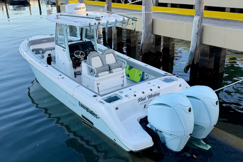 The Image of 2023 Everglades 285 Center Console boat docked, featuring dual engines and modern design. - 0