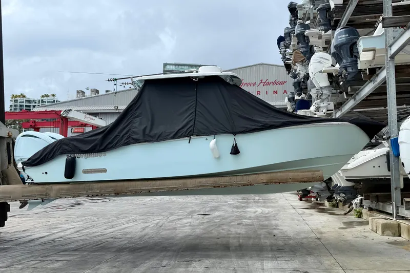 Slide: The Image of 2023 Everglades 285 Center Console boat interior with cushioned seating and cup holders. - 1